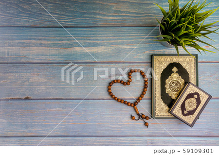 Flat lay view of vase, tasbih and Holy book of Al Quran Flat lay view of vase, tasbih and Holy book of Al Quran 59109301