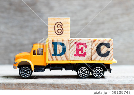 Truck hold letter block in word 6dec on wood background Truck hold letter block in word 6dec on wood background 59109742