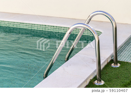 Inox railings in the pool on the grass. 59110407