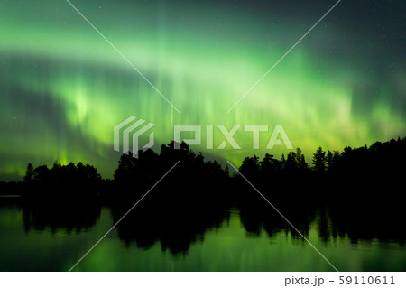 Northern lights over lake in Finland 59110611