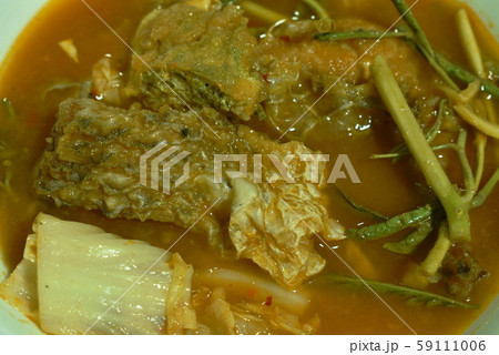 fried fish and egg stuffed climbing wattle in spicy sour soup on bowl 59111006
