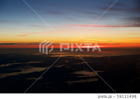 OSLO, NORWAY - JAN 21st, 2017: View off the sunrise, norway during winter from inside the plane OSLO, NORWAY - JAN 21st, 2017: View off the sunrise, norway during winter from inside the plane 59111498