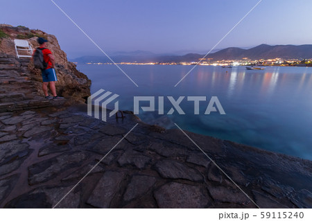 the guy on the edge of the cliff looks into the distance 59115240