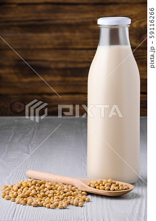 Bottle of soy milk with soybeans on white table Bottle of soy milk with soybeans on white table 59116266