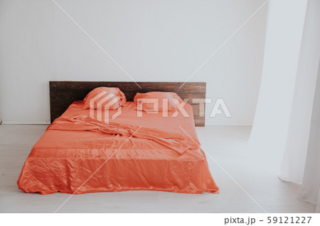 the Interior of the white room with a bed with red 59121227