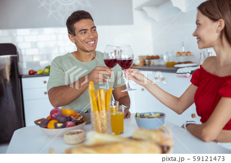 Positive delighted young couple enjoying their conversation 59121473