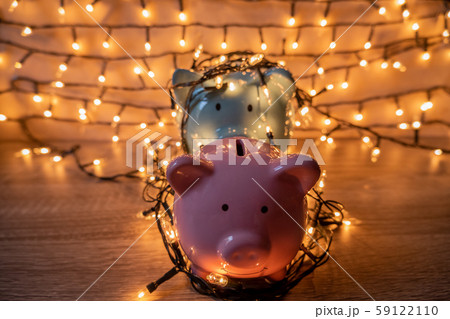 Pink and blue piggy bank with glittering lights, organize parties for successful activities to save money for retirement 59122110