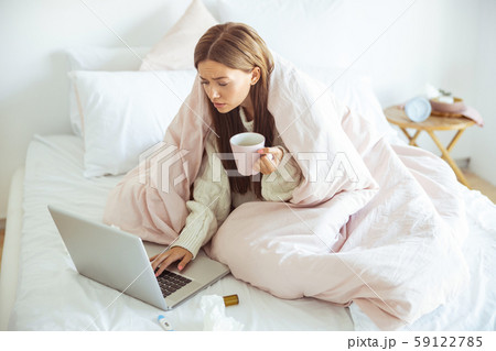 Concentrated girl reading income message on gadget Concentrated girl reading income message on gadget 59122785