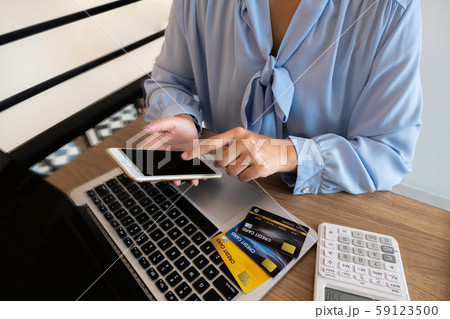 Business woman consumer holding credit card and smartphone for online shopping and payment make a purchase on the Internet Business woman consumer holding credit card and smartphone for online shopping and payment make a purchase on the Internet 59123500