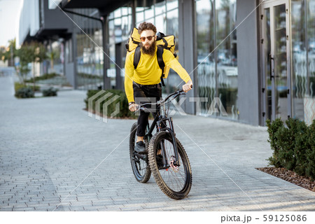 Courier delivering food on a bicycle 59125086