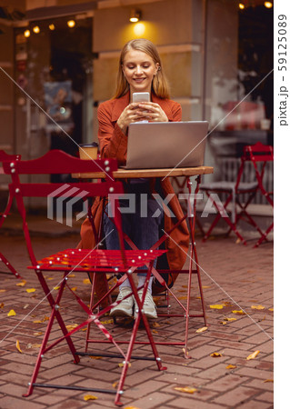 Pretty Caucasian girl using a cellphone outside Pretty Caucasian girl using a cellphone outside 59125089