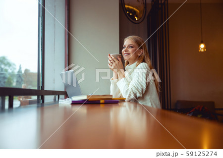Woman resting her elbows on the table 59125274