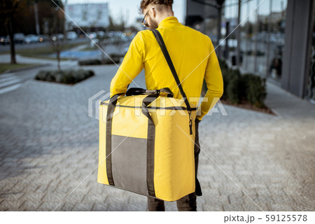 Courier carrying thermal bag, delivering food 59125578