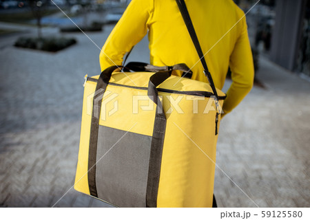 Courier carrying thermal bag, delivering food Courier carrying thermal bag, delivering food 59125580