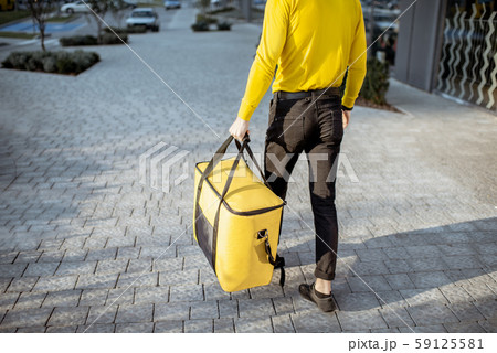 Courier carrying thermal bag, delivering food 59125581
