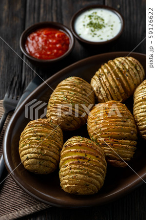 Hasselback potatoes baked with garlic and herbs Hasselback potatoes baked with garlic and herbs 59126622