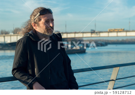 Handsome middle age man standing leaned on the 59128712