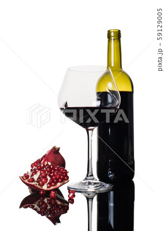 bottle and wineglass with pomegranate wine 59129005