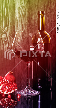 bottle and wineglass with pomegranate wine bottle and wineglass with pomegranate wine 59129006