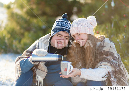 Young couple in love drink a hot drink from a 59131175