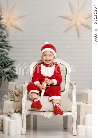Happy little smiling boy in santa claus costume 59131507