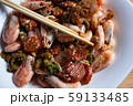 Cooked tasty dish fried shrimp with vegetables in sweet and sour sauce. Carrots, broccoli, cauliflower, shrimp are on a white plate. 59133485