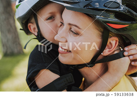 Little girl hugging mother and kissing her cheek 59133638