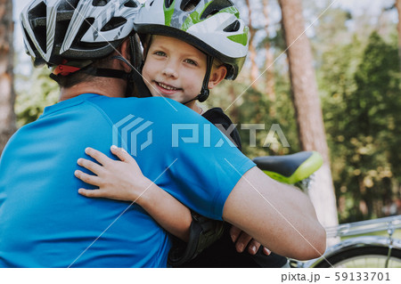 Cute little girl and her father hugging outdoors 59133701