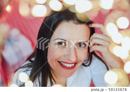 Closeup photo of lovely woman in celebrating atmosphere, looking at the camera, smiling. Closeup photo of lovely woman in celebrating atmosphere, looking at the camera, smiling. 59133878