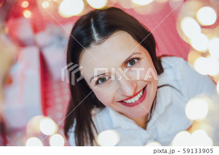 Closeup photo of lovely woman in celebrating atmosphere, looking at the camera, smiling. Closeup photo of lovely woman in celebrating atmosphere, looking at the camera, smiling. 59133905