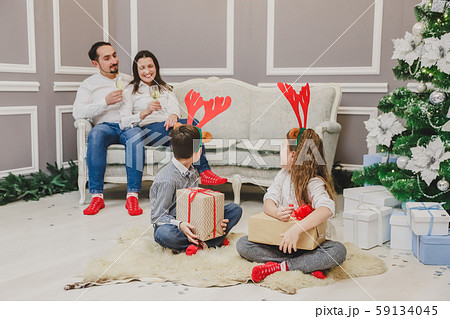 Caucasian family exchanging gifts on Christmas Eve. 59134045
