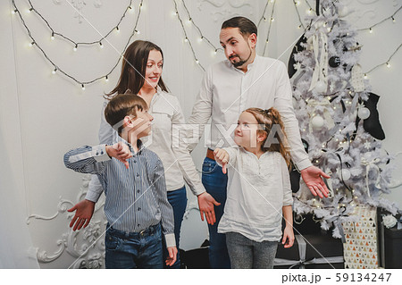 New year photo with children looking at their parents with angry faces, negative signs showing New year photo with children looking at their parents with angry faces, negative signs showing 59134247