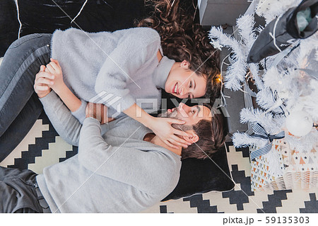 Noel evening and family gathering concept. New Year mood of young people in love. 59135303