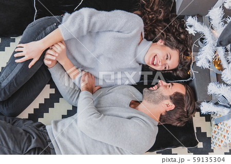 Danish hygge and homely environment concept. Up-view photo of lovely couple enjoying christmas time 59135304