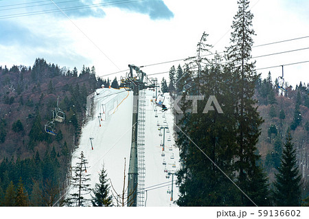 Ski slope with lift on the background of evergreen Ski slope with lift on the background of evergreen 59136602