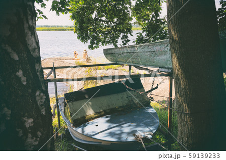 Two sunbathe on the river in summer 59139233