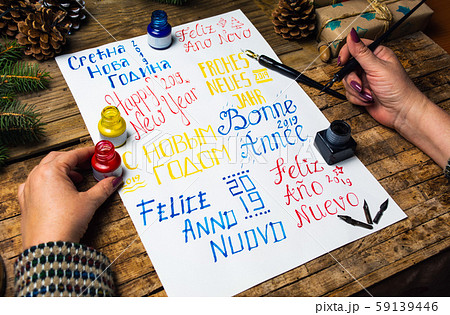 Writing a Happy new year card in various languages Writing a Happy new year card in various languages 59139446