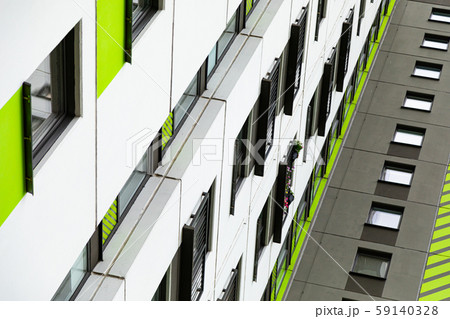 Bottom view of high new multiple dwelling of white, green and grey colors 59140328