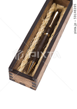 Beautiful wooden box with ballpoint pen inside on 59146395