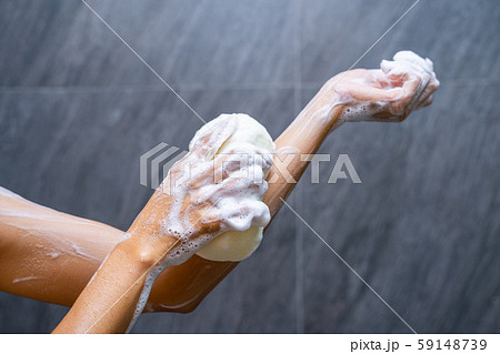 woman shower with body scrub sponge 59148739