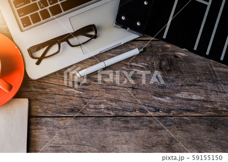 Office accessories laptop, smartphone, notepad, and coffee cup on a wooden table background. View from above. Office accessories laptop, smartphone, notepad, and coffee cup on a wooden table background. View from above. 59155150