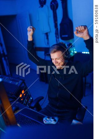 Male gamer with raised hands, tournament winner Male gamer with raised hands, tournament winner 59160638