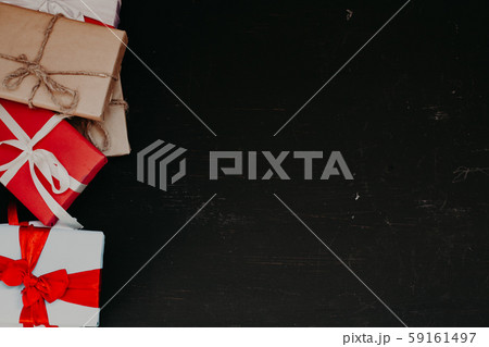 lots of holiday gifts for Christmas birthday on a dark background 59161497