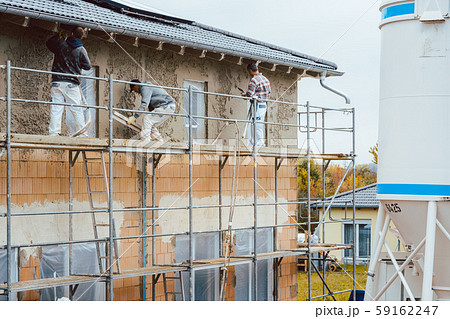 Plaster worker on scaffold working Plaster worker on scaffold working 59162247