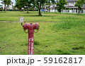 red  fire hydrant sits in a freshly cut grass field. 59162817