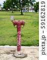 red  fire hydrant sits in a freshly cut grass field. 59162819