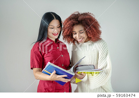 International female friends studying foreign language together International female friends studying foreign language together 59163474