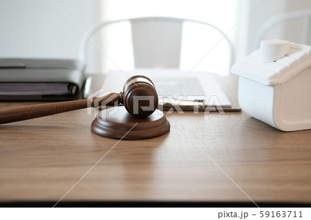 judge gavel & house model on wooden desk. real estate dispute & property auction concept judge gavel & house model on wooden desk. real estate dispute & property auction concept 59163711