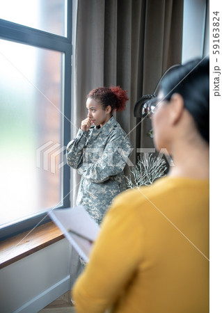 Servicewoman standing near window while visiting psychoanalyst 59163824