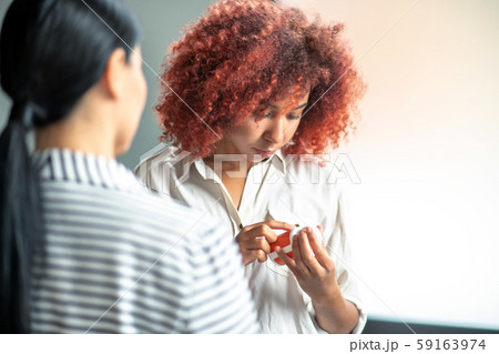 Curly stressed woman reading description of antidepressants 59163974